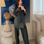 Pakistani actress Sajal Aly wearing a dark green embroidered 2-piece cotton suit with wide-leg trousers Lubaba Luxury.