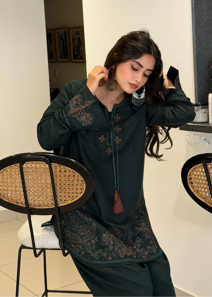 Pakistani actress Sajal Aly wearing a dark green embroidered 2-piece cotton suit with wide-leg trousers Lubaba Luxury.