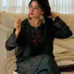 Pakistani actress Sajal Aly wearing a dark green embroidered 2-piece cotton suit with wide-leg trousers Lubaba Luxury.