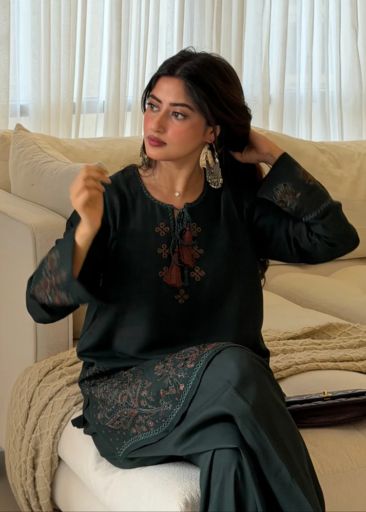 Pakistani actress Sajal Aly wearing a dark green embroidered 2-piece cotton suit with wide-leg trousers Lubaba Luxury.