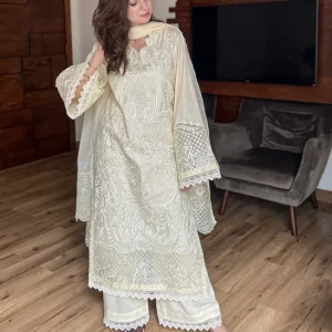 Model wearing Iznik 3-piece heavy embroidered off-white lawn suit with organza dupatta and lace trousers lubaba luxury.