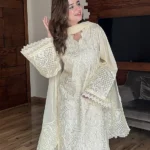Model wearing Iznik 3-piece heavy embroidered off-white lawn suit with organza dupatta and lace trousers lubaba luxury.