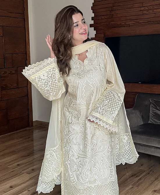 Model wearing Iznik 3-piece heavy embroidered off-white lawn suit with organza dupatta and lace trousers lubaba luxury.