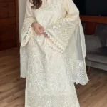 Model wearing Iznik 3-piece heavy embroidered off-white lawn suit with organza dupatta and lace trousers lubaba luxury.