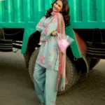 Woman wearing a Minha 3-piece grip silk suit in pastel blue with pink floral embroidery and a matching chiffon dupatta lubaba luxury.