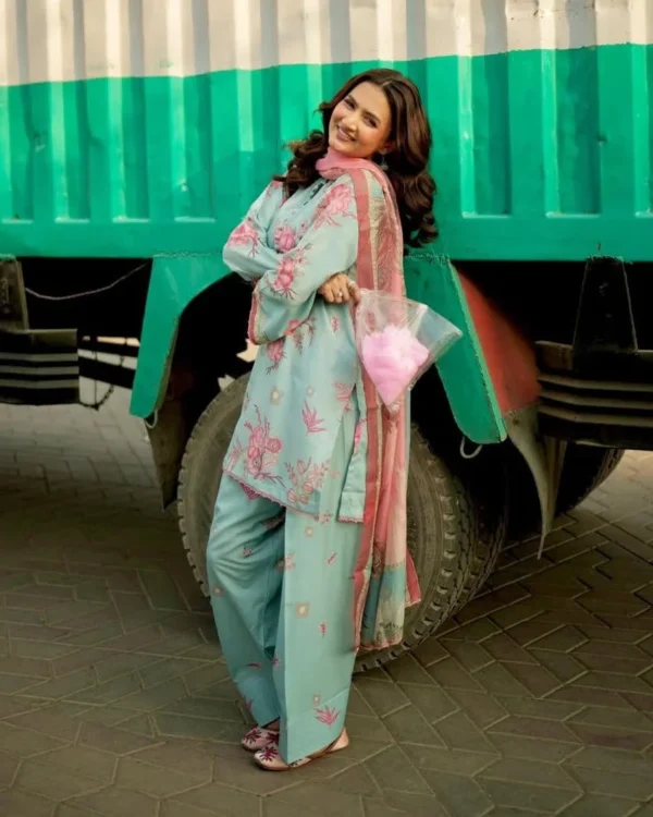 Woman wearing a Minha 3-piece grip silk suit in pastel blue with pink floral embroidery and a matching chiffon dupatta lubaba luxury.