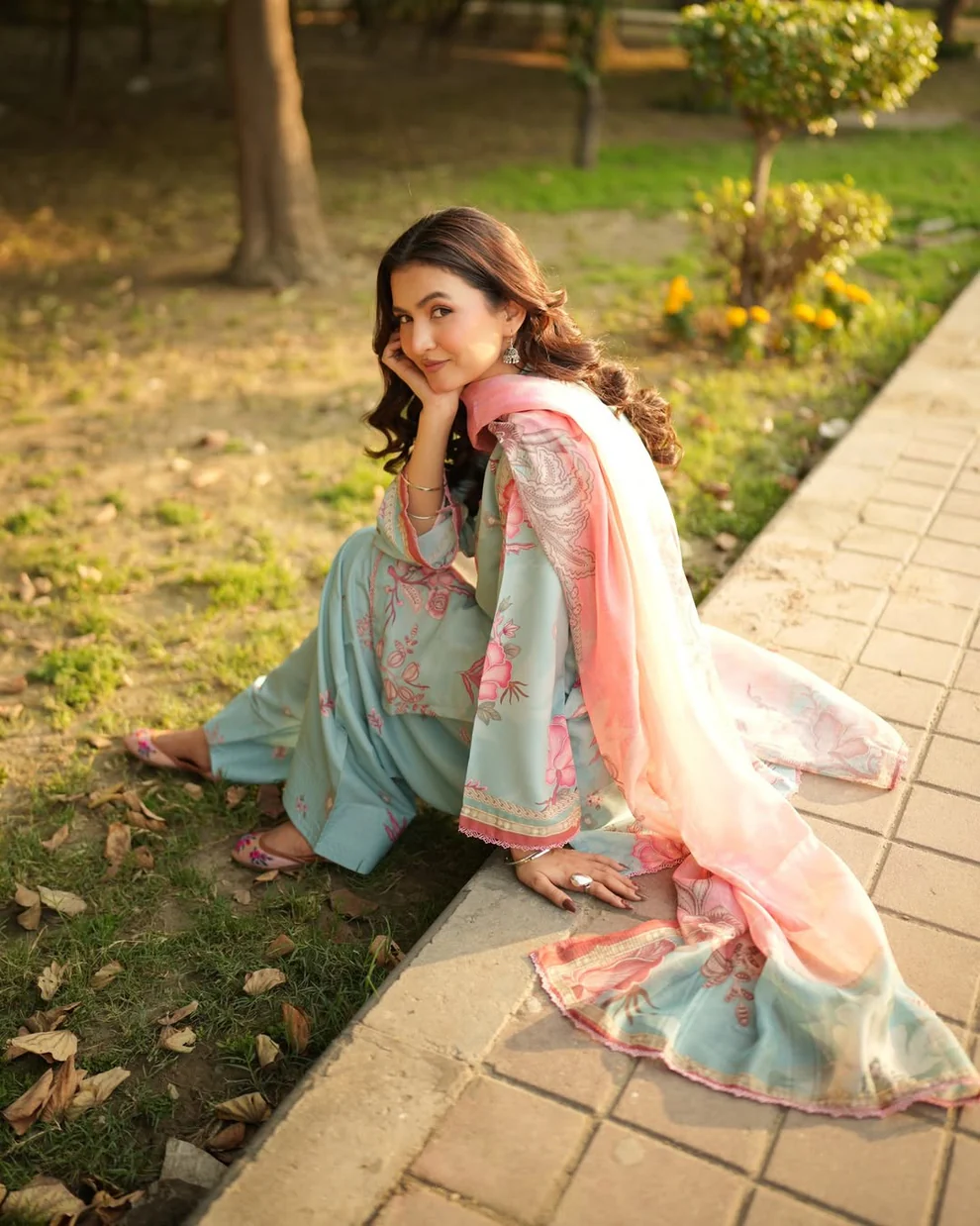 Woman wearing a Minha 3-piece grip silk suit in pastel blue with pink floral embroidery and a matching chiffon dupatta lubaba luxury.
