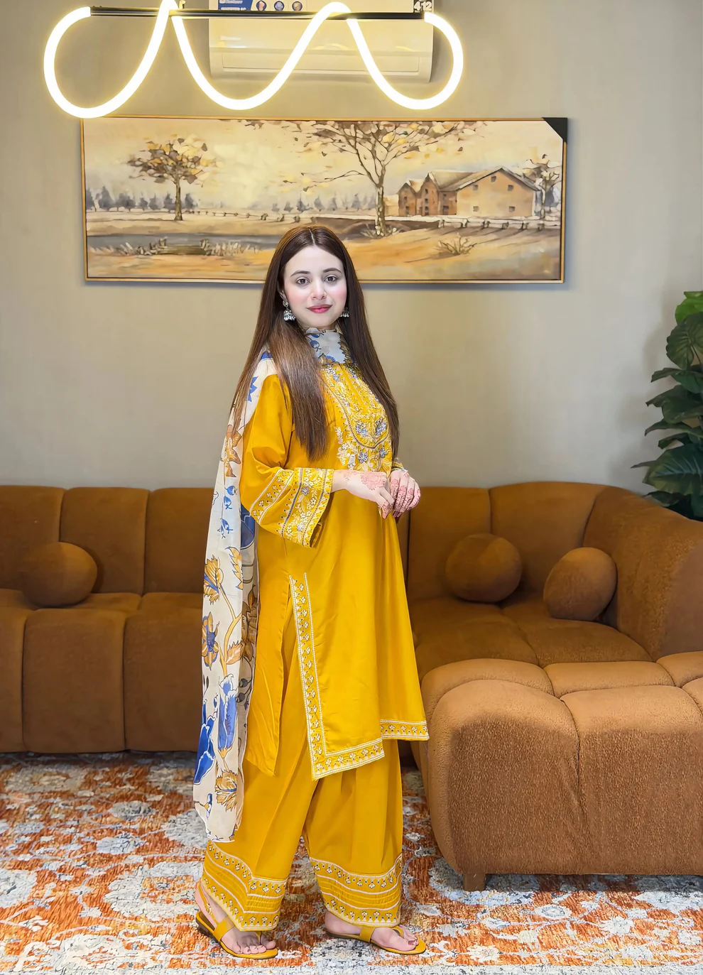 A mustard yellow 3-piece embroidered cotton suit with a Munaar dupatta, featuring white lace detailing on the sleeves and hem Lubaba Luxury.