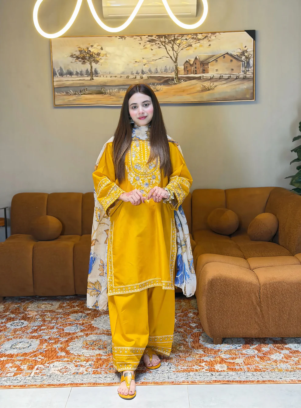 A mustard yellow 3-piece embroidered cotton suit with a Munaar dupatta, featuring white lace detailing on the sleeves and hem Lubaba Luxury.