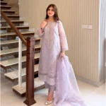 Woman wearing a lilac 3-piece embroidered organza suit with a matching dupatta and trousers lubaba luxury.
