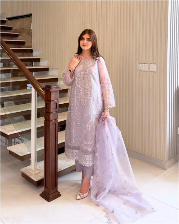 Woman wearing a lilac 3-piece embroidered organza suit with a matching dupatta and trousers lubaba luxury.
