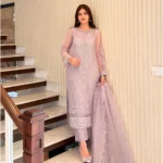 Woman wearing a lilac 3-piece embroidered organza suit with a matching dupatta and trousers lubaba luxury.