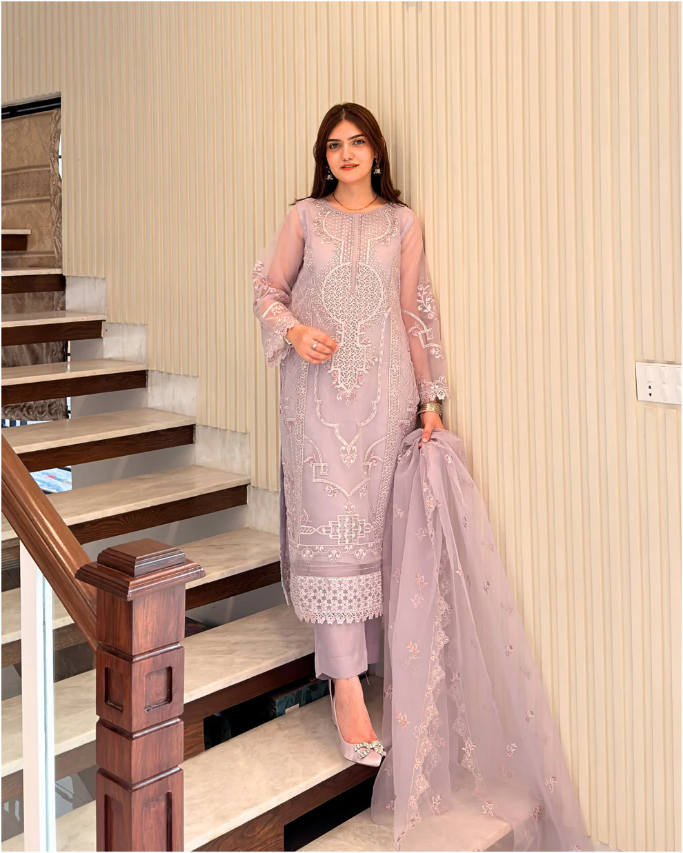 Woman wearing a lilac 3-piece embroidered organza suit with a matching dupatta and trousers lubaba luxury.