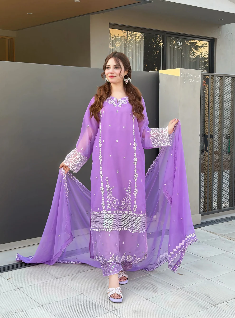 Women wearing a lavender purple embroidered chiffon 3-piece suit with a long straight shirt and matching dupatta from Lubaba Luxury.