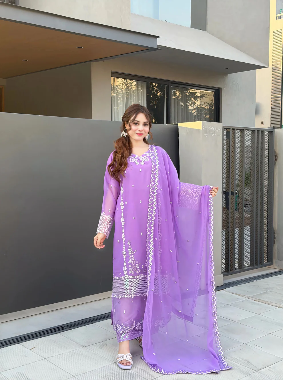 Women wearing a lavender purple embroidered chiffon 3-piece suit with a long straight shirt and matching dupatta from Lubaba Luxury.