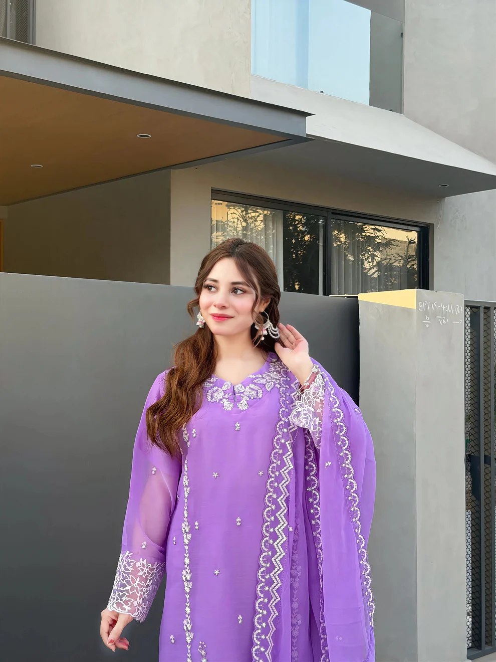 Women wearing a lavender purple embroidered chiffon 3-piece suit with a long straight shirt and matching dupatta from Lubaba Luxury.