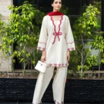 Ivory cotton Pakistani 3-piece suit with red bow embroidery and red dupatta by Lubaba Luxury.