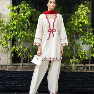 Ivory cotton Pakistani 3-piece suit with red bow embroidery and red dupatta by Lubaba Luxury.