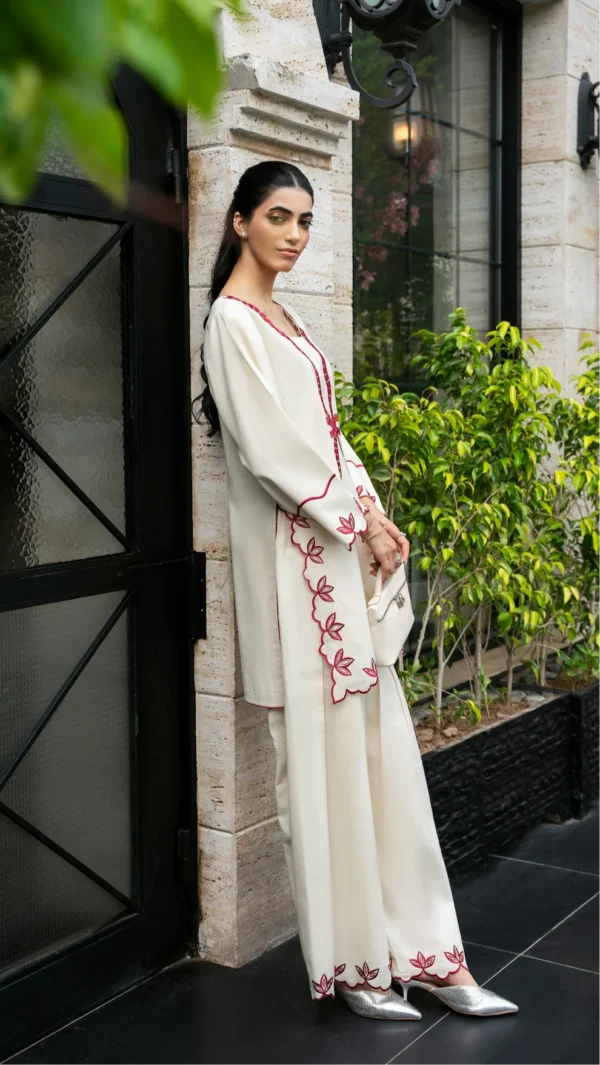 Ivory cotton Pakistani 3-piece suit with red bow embroidery and red dupatta by Lubaba Luxury.