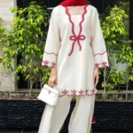 Ivory cotton Pakistani 3-piece suit with red bow embroidery and red dupatta by Lubaba Luxury.