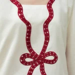 Ivory cotton Pakistani 3-piece suit with red bow embroidery and red dupatta by Lubaba Luxury.