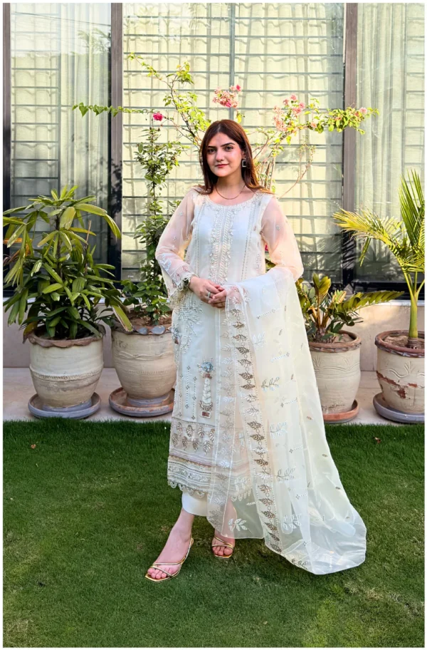 White 3-piece organza suit with intricate embroidery and a matching net dupatta by Lubaba Luxury.