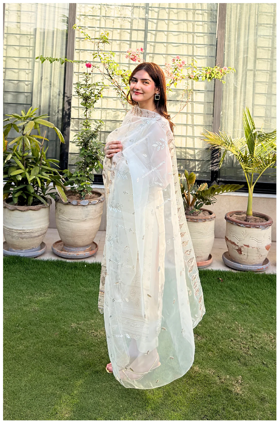 White 3-piece organza suit with intricate embroidery and a matching net dupatta by Lubaba Luxury.