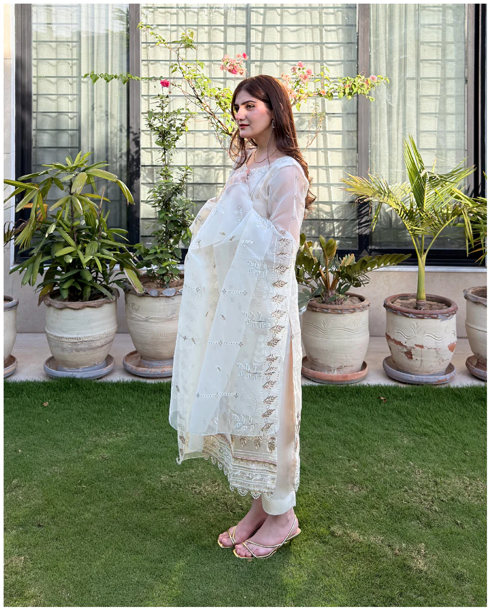 White 3-piece organza suit with intricate embroidery and a matching net dupatta by Lubaba Luxury.