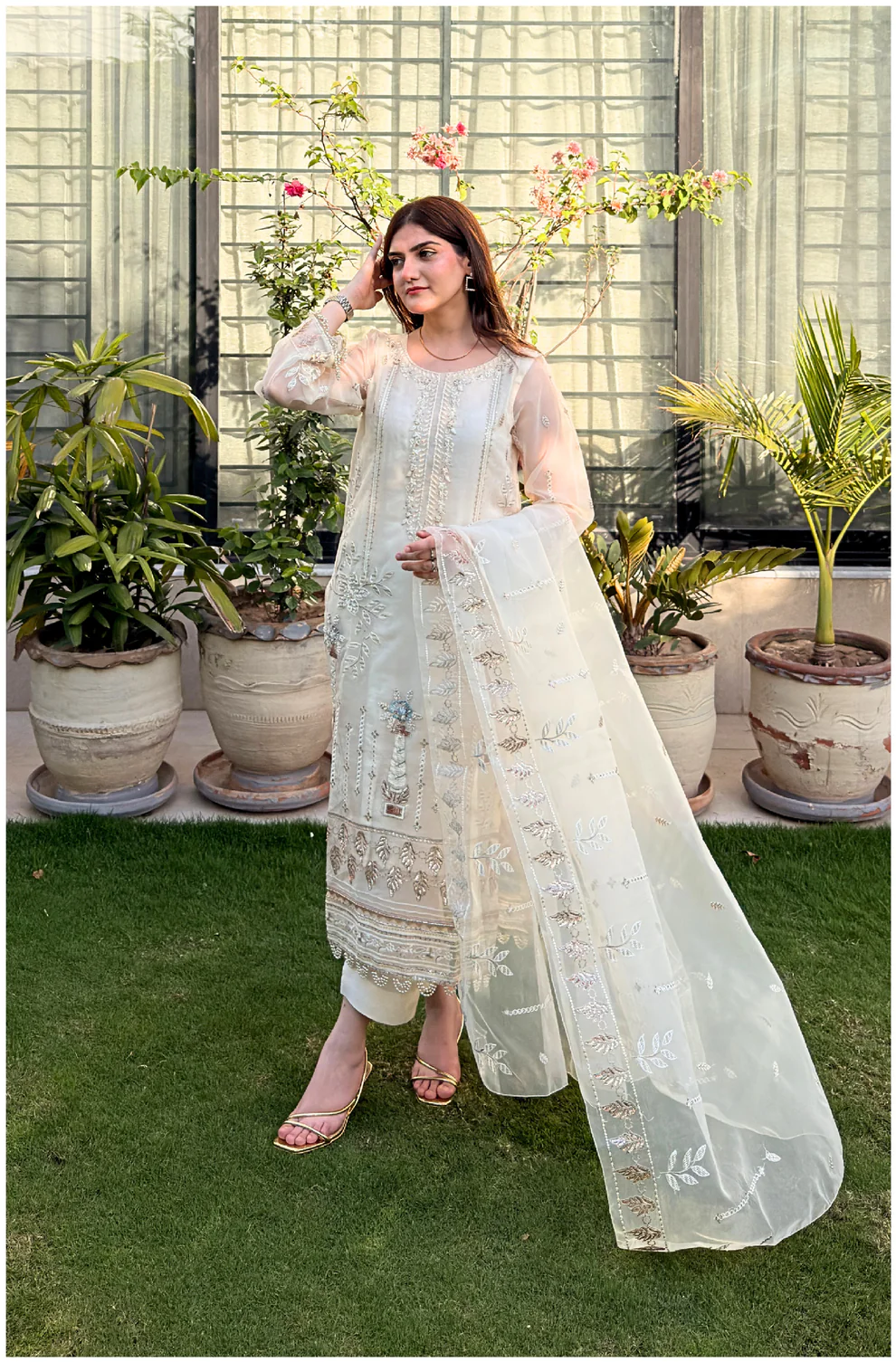 White 3-piece organza suit with intricate embroidery and a matching net dupatta by Lubaba Luxury.