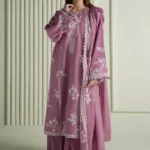 Model wearing a mauve Cross Stitch Orchid Glaze 3-piece embroidered lawn suit with a matching dupatta lubaba luxury.