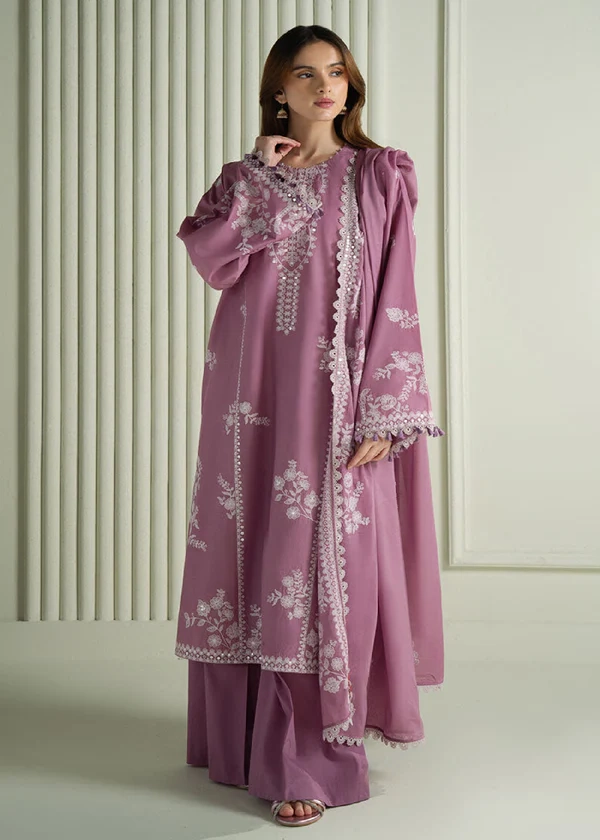 Model wearing a mauve Cross Stitch Orchid Glaze 3-piece embroidered lawn suit with a matching dupatta lubaba luxury.