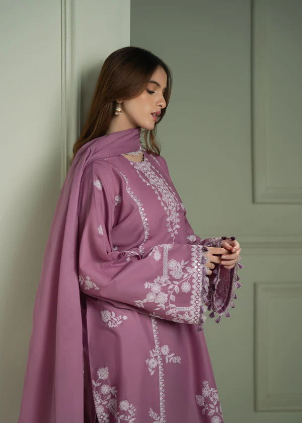 Model wearing a mauve Cross Stitch Orchid Glaze 3-piece embroidered lawn suit with a matching dupatta lubaba luxury.
