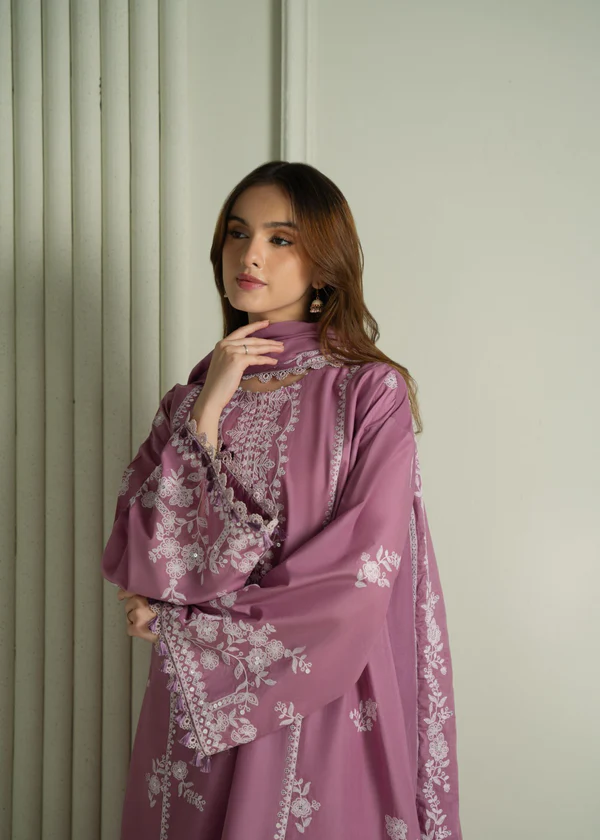 Model wearing a mauve Cross Stitch Orchid Glaze 3-piece embroidered lawn suit with a matching dupatta lubaba luxury.