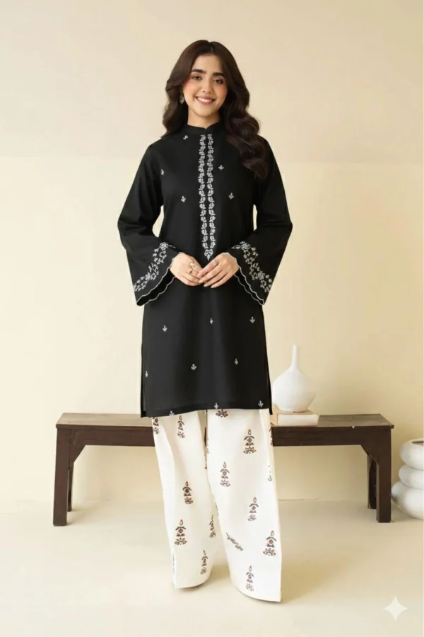 Close-up of Black embroidered lawn shirt with white threadwork and matching trousers.