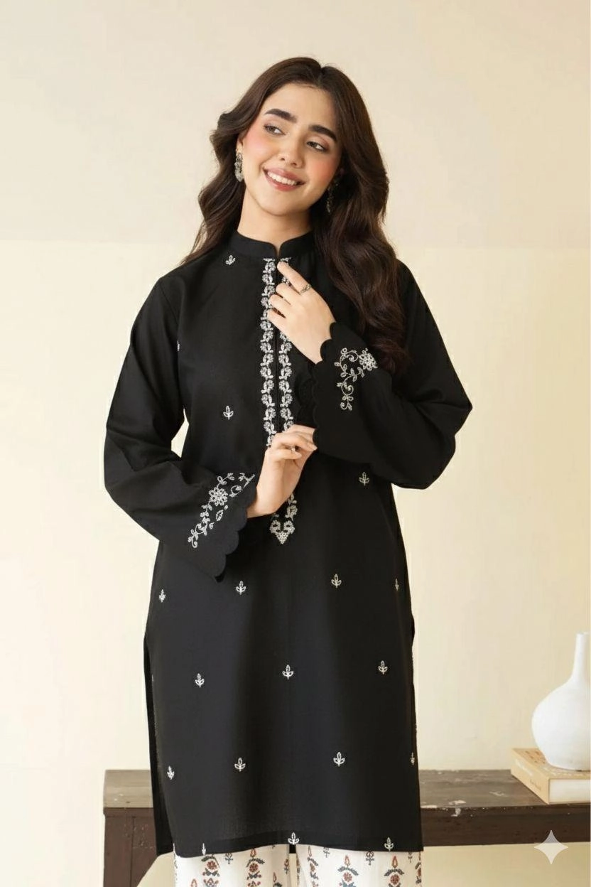 Close-up of Black embroidered lawn shirt with white threadwork and matching trousers.
