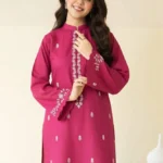 Close-up of Magenta embroidered lawn shirt with white threadwork and matching trousers.