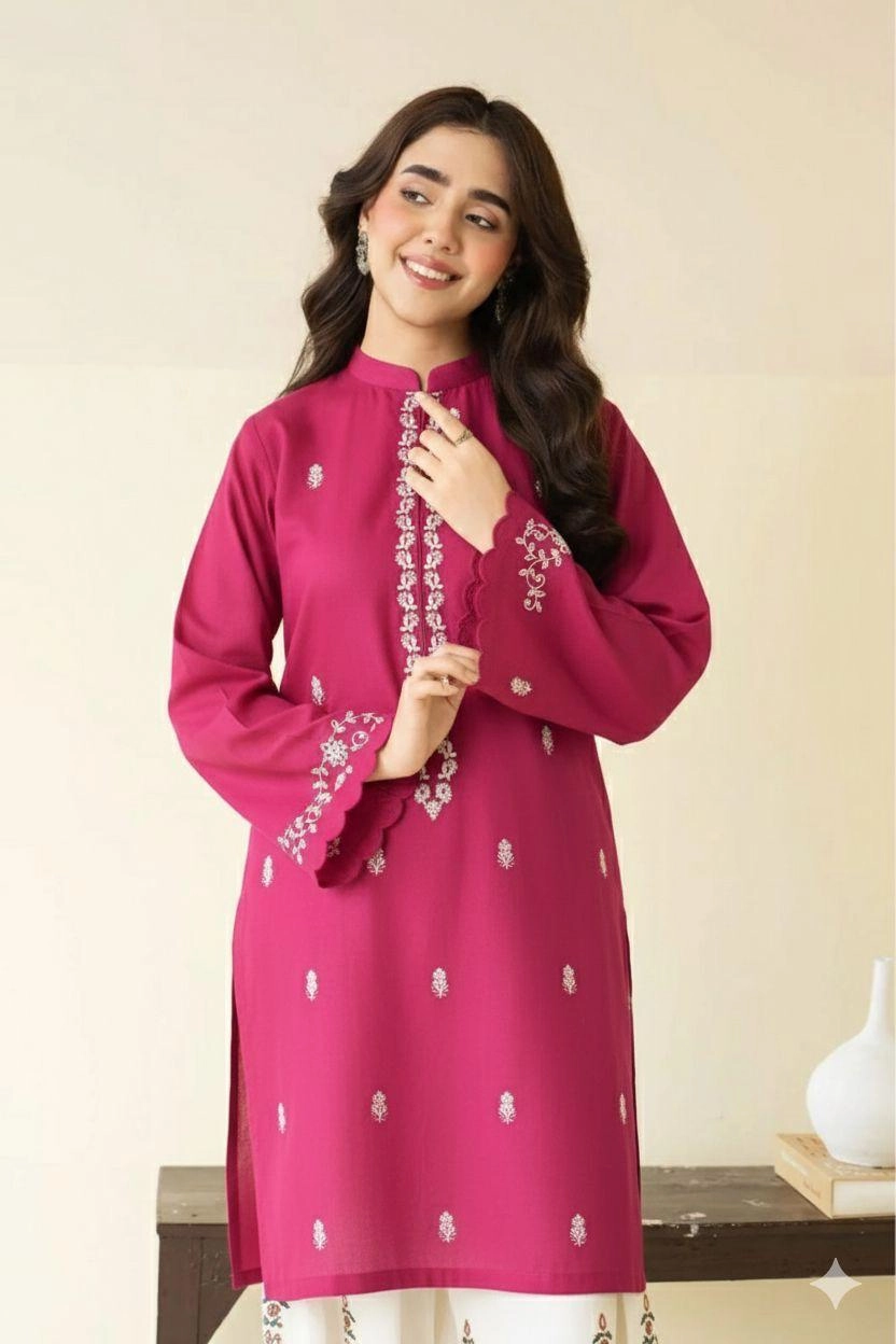 Close-up of Magenta embroidered lawn shirt with white threadwork and matching trousers.