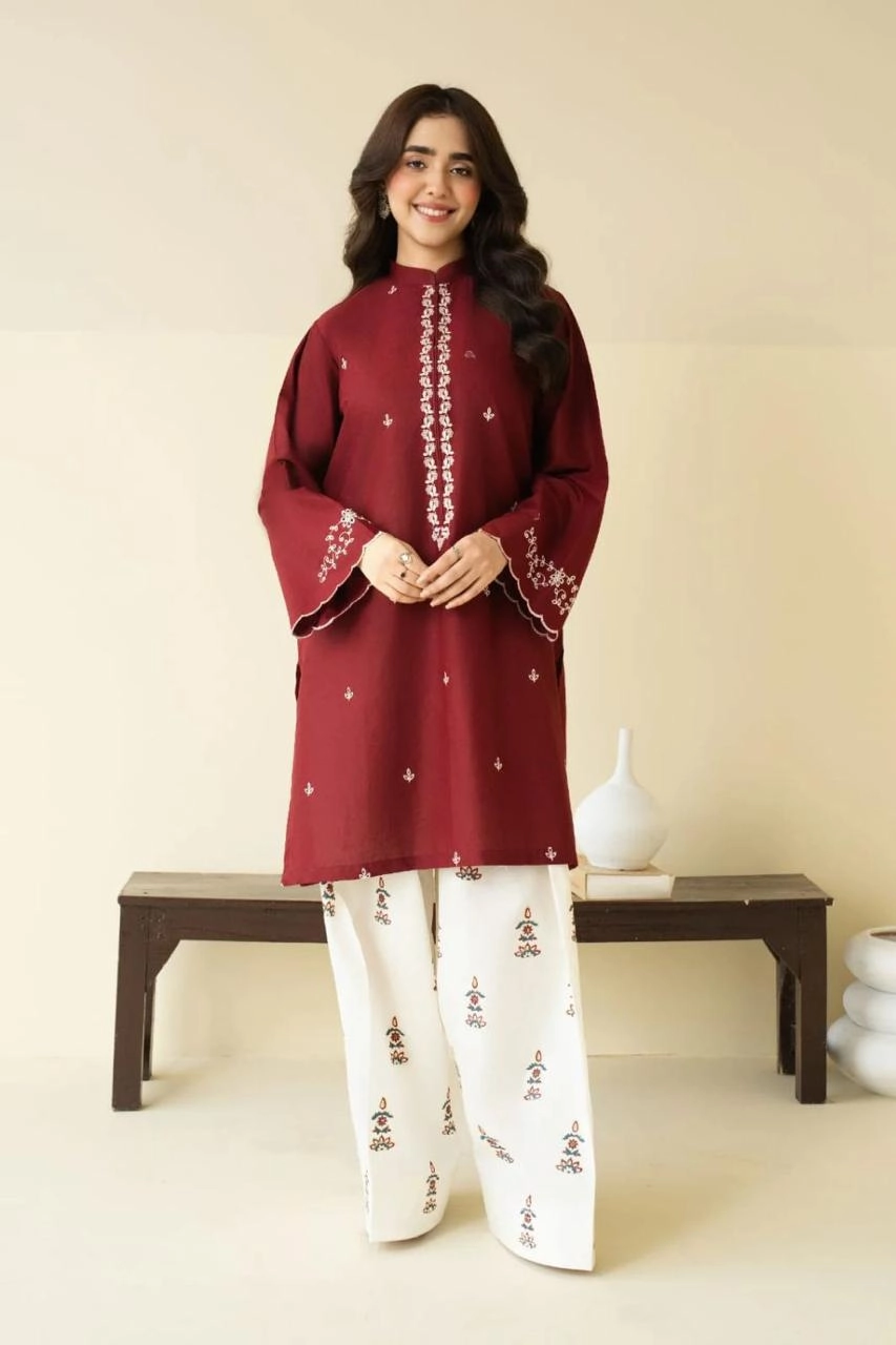 Close-up of Maroon embroidered lawn shirt with white threadwork and matching trousers.